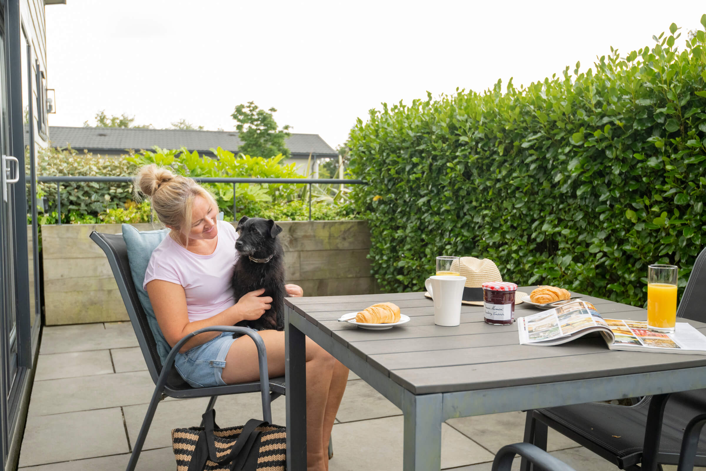 lady and her dog with breakfast on decking at St Mabyn Cornwall